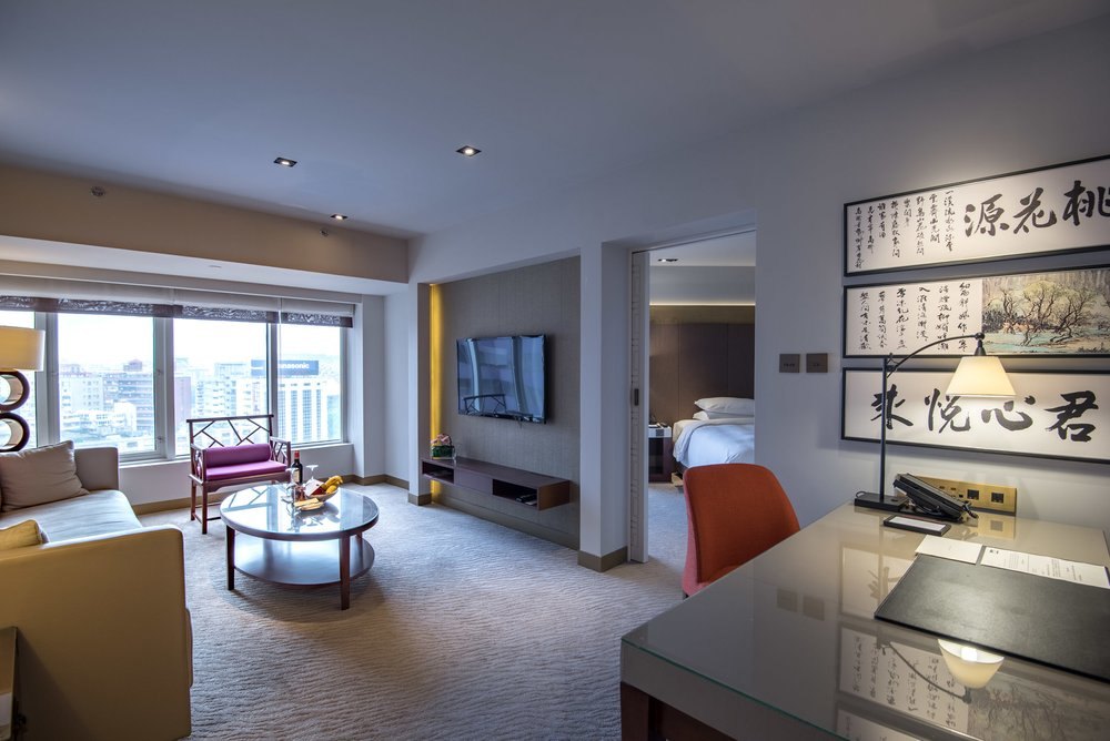 Living room and separate bedroom in a Grand Suite, the standard suite category at Grand Hyatt Taipei
