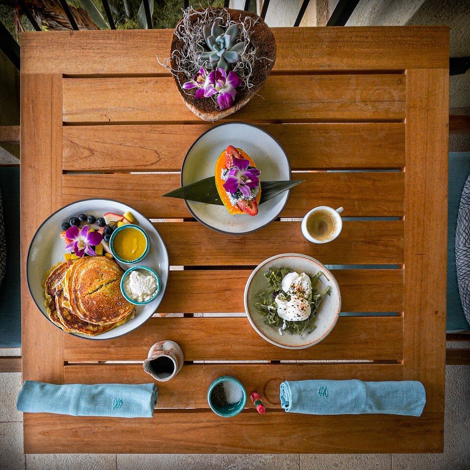 Breakfast dishes served on a wooden table at Hotel Wailea